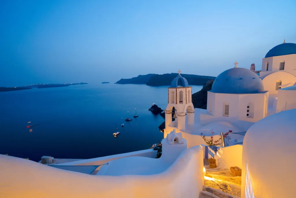 Oia nell'ora blu, con le luci che si accendono lungo la caldera